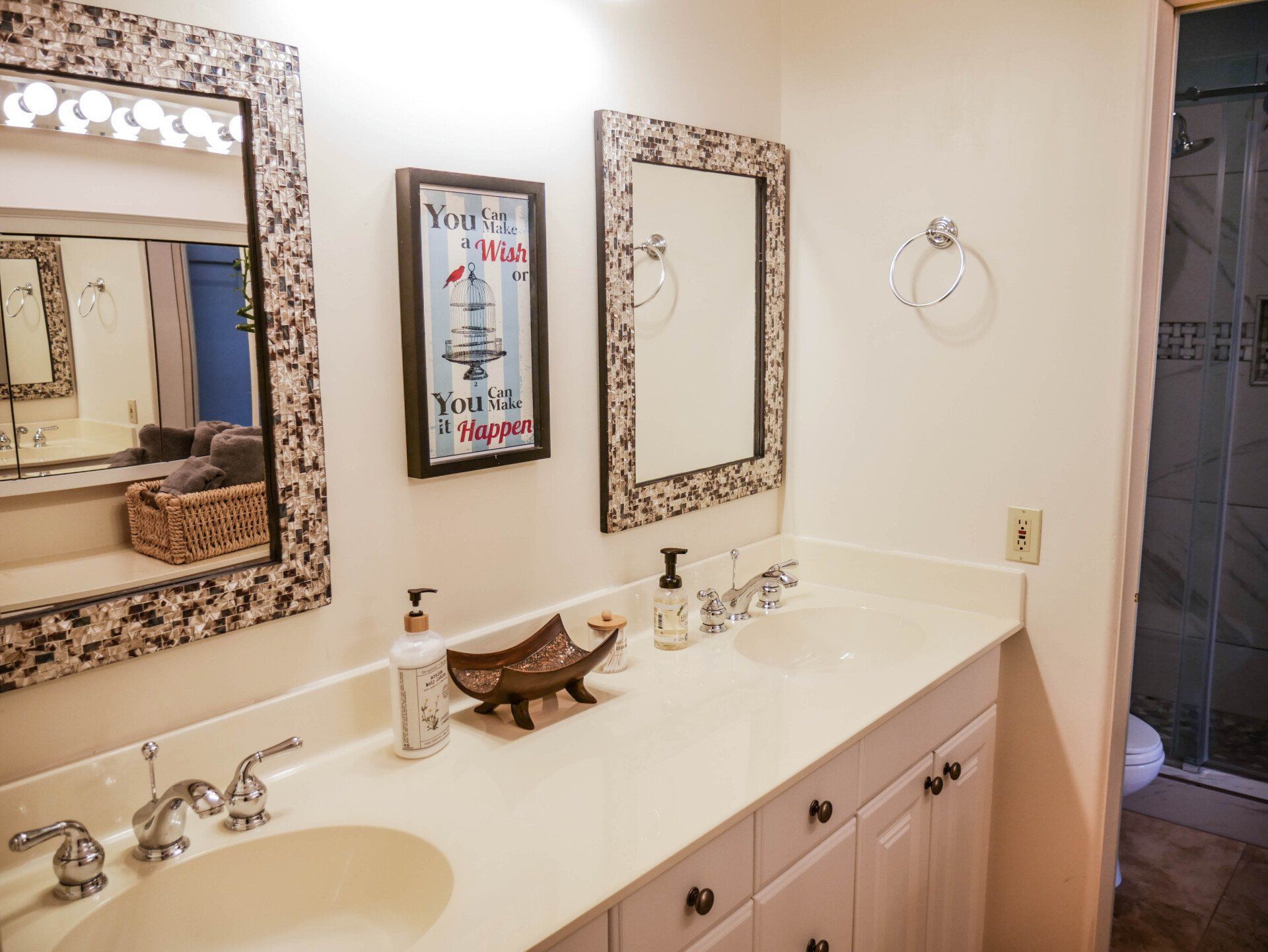 A bathroom with two sinks and two mirrors.