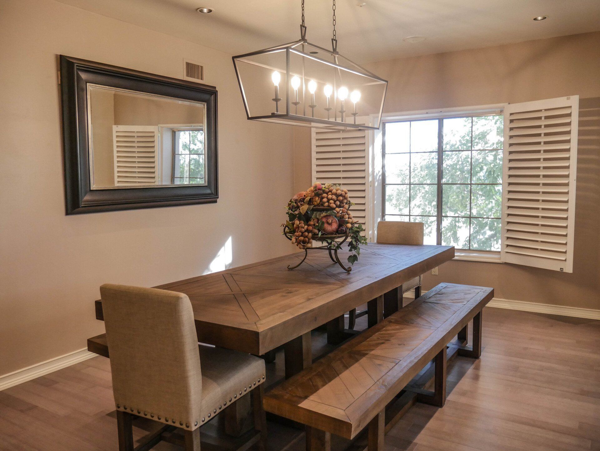 A dining room with a long wooden table and benches.