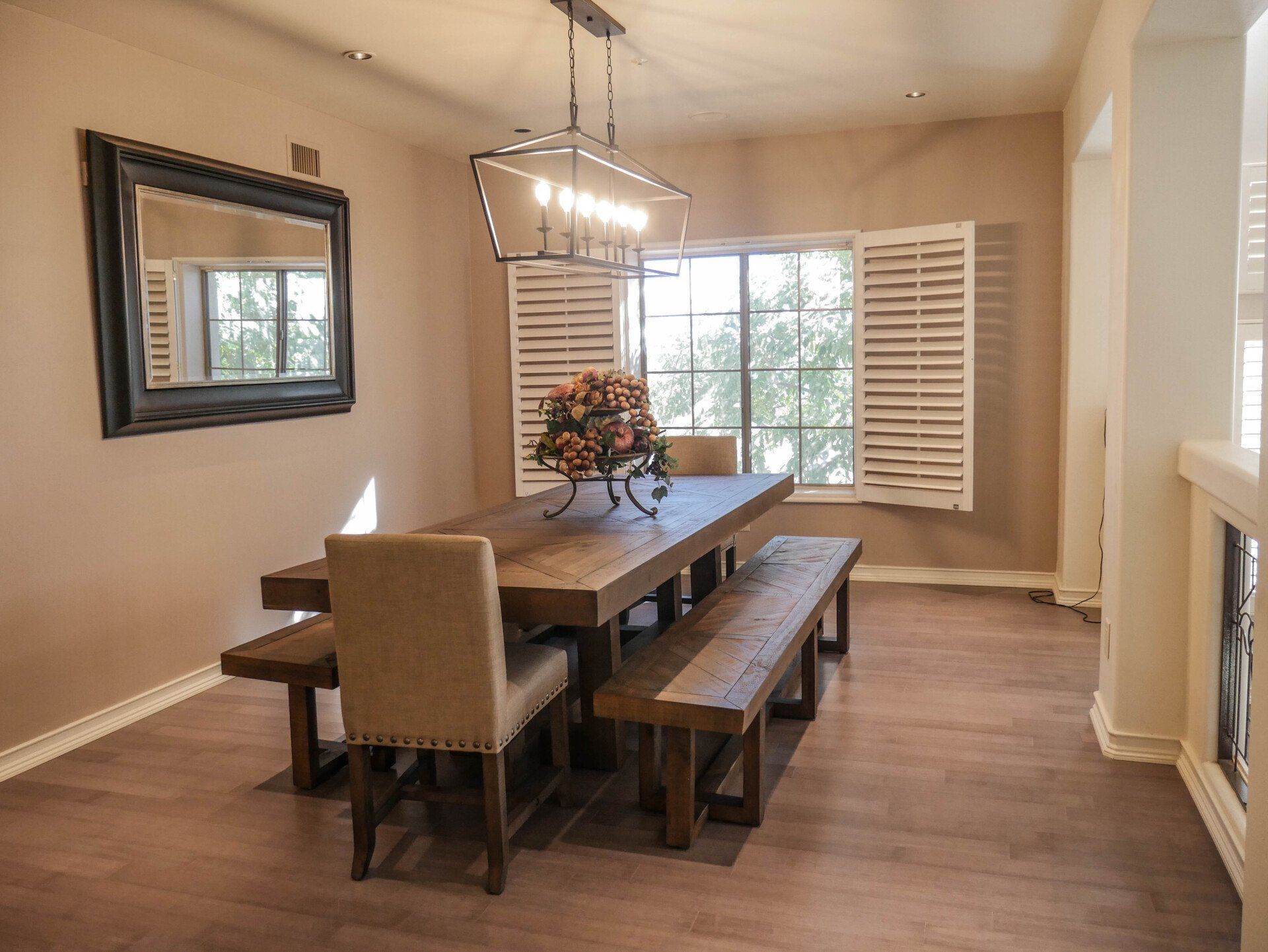 A dining room with a long wooden table and benches