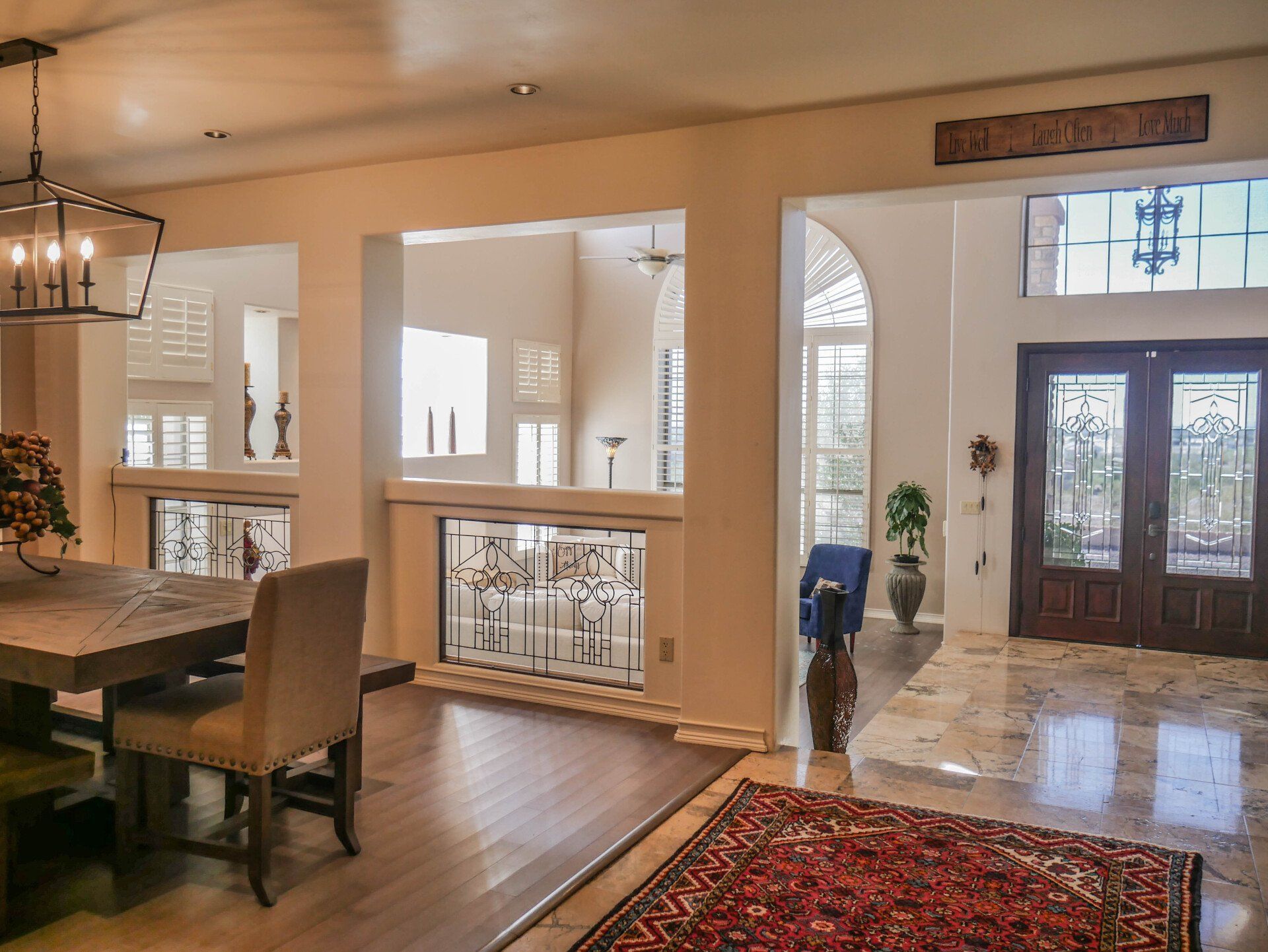 A dining room with a table and chairs and a rug