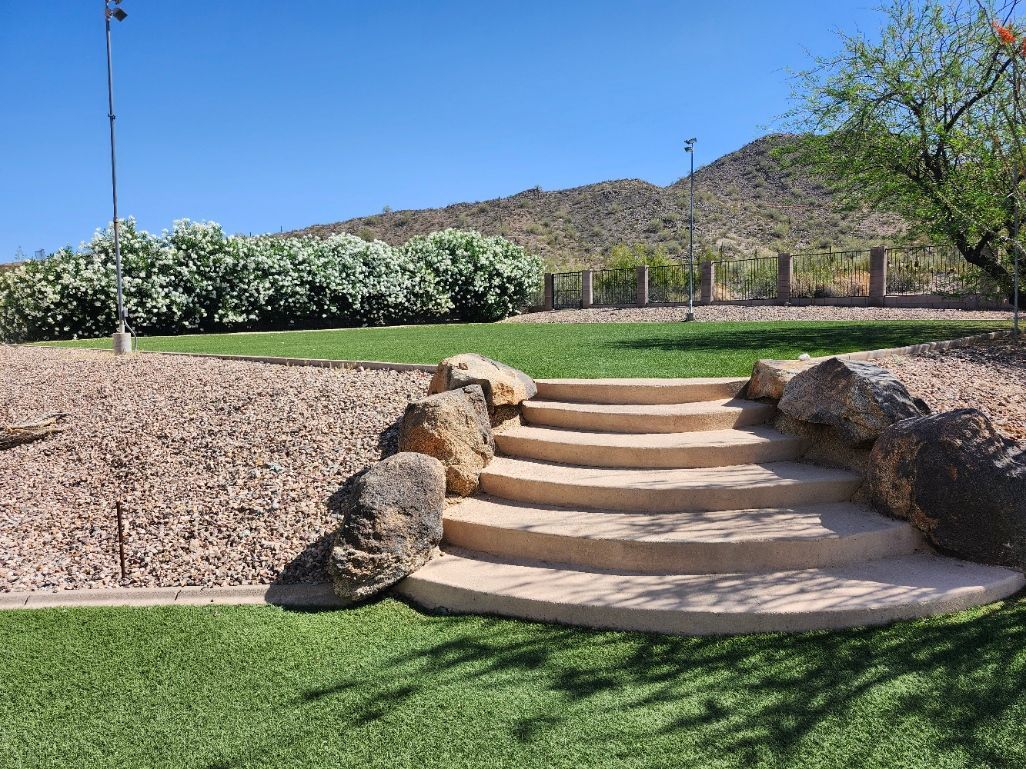 A large swimming pool in the backyard of a house with mountains in the background.