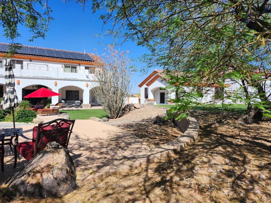 A large house with a large swimming pool in front of it.