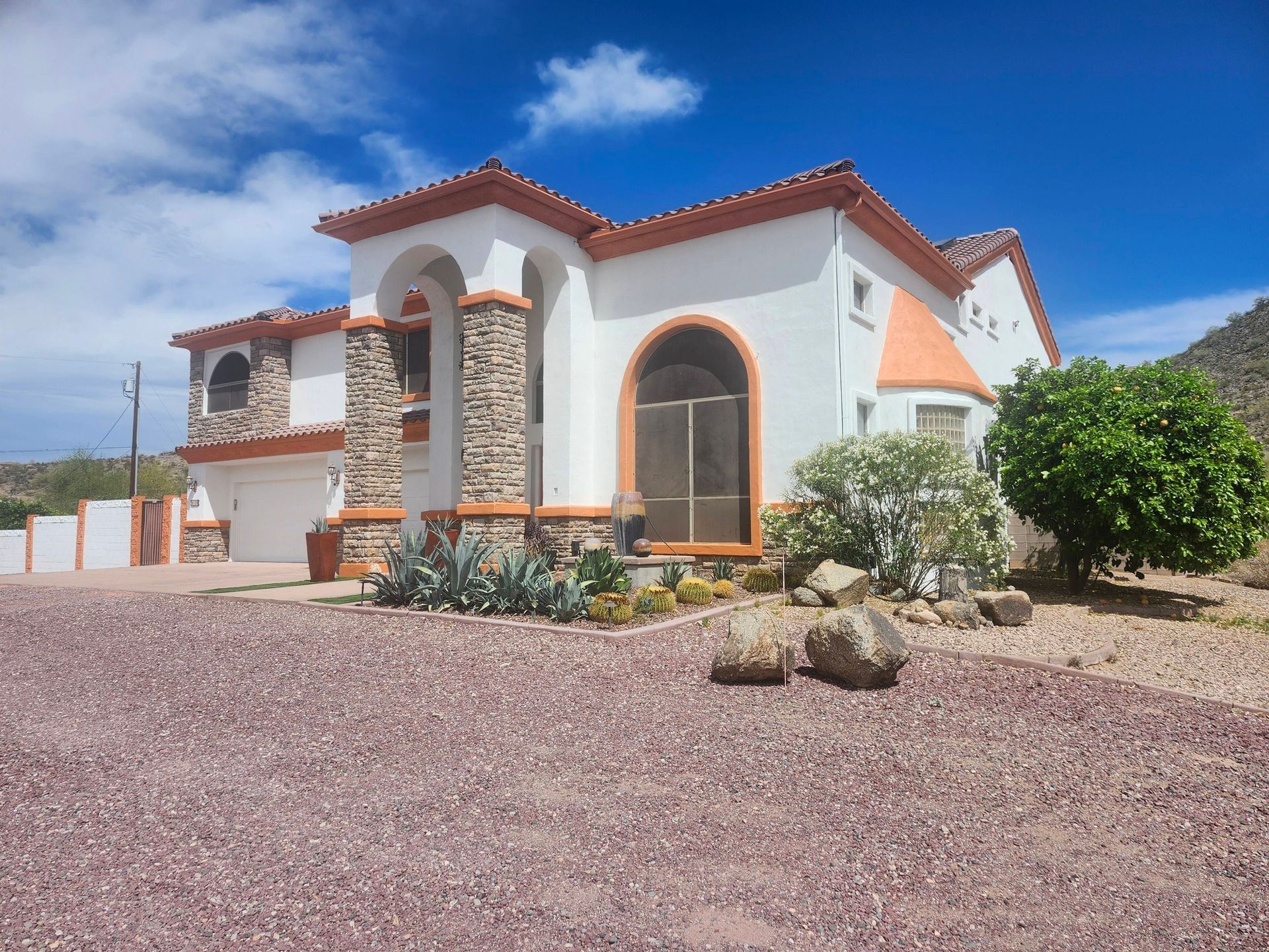 The front of a large house is lit up at night.