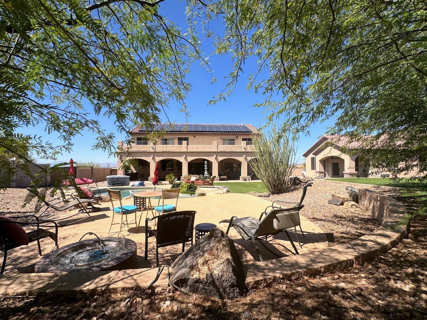 A large house with a fire pit in front of it.
