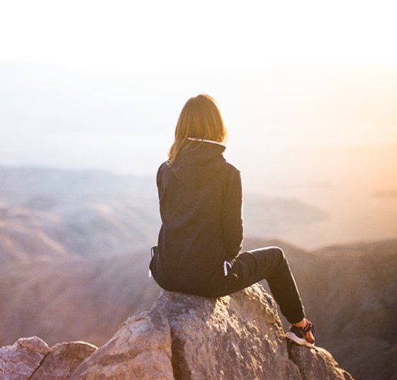 A woman sitting on a rock