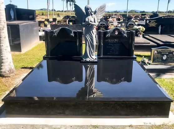 A Grave With a Statue of an Angel on Top of It — Mackay Monumental Masons In Glenella, QLD