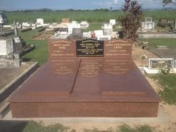 Red granite headstone in a cemetery; names and dates inscribed — Mackay Monumental Masons In Glenella, QLD