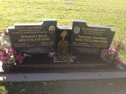 Two-part tombstone with inscriptions for Eleanor and Norman Shuttlewood, featuring photos, flowers, and a central tree design — Mackay Monumental Masons In Glenella, QLD