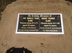 Grave marker with two inscriptions: Kay Peace Clark (died 1971) and Robert Clark (died 1992), set in sand — Mackay Monumental Masons In Glenella, QLD