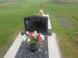 Gravestone with flowers, cross, and name
