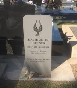White gravestone with the name David John Skinner, dates 1977-2011, and a winged design — Mackay Monumental Masons In Glenella, QLD