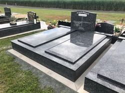 Dark gray granite headstones in a cemetery — Mackay Monumental Masons In Glenella, QLD