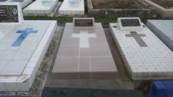 Headstones in a Cemetery With Crosses, the Middle One Has a Small Plaque — Mackay Monumental Masons In Glenella, QLD