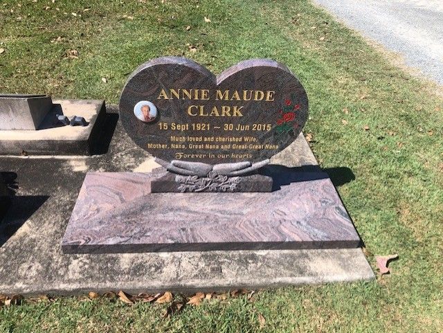 Heart-shaped headstone with photo, engraved text