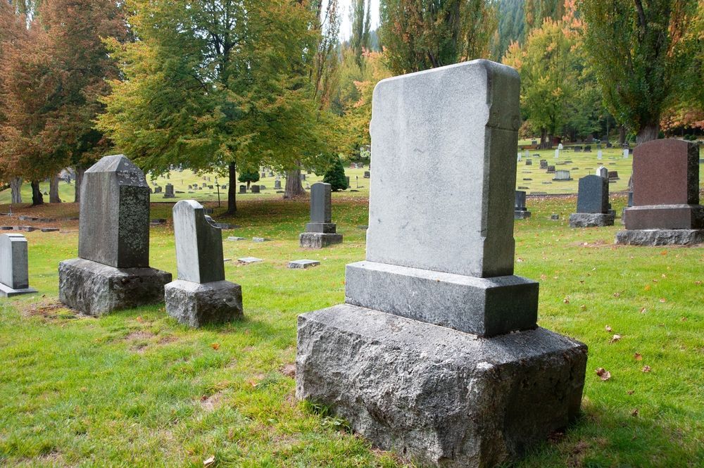 Grey Headstone In A Graveyard