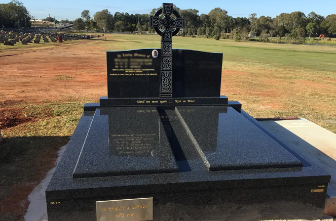 A Black Granite Headstone With a Celtic Cross Atop — Mackay Monumental Masons In Glenella, QLD