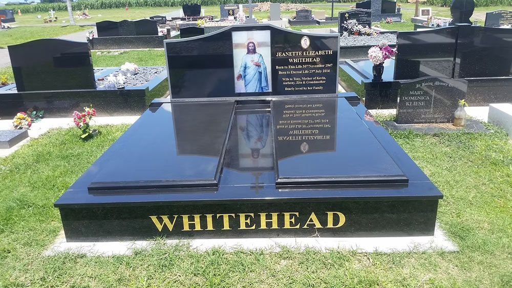 Black Granite Headstone in a Cemetery — Mackay Monumental Masons In Glenella, QLD