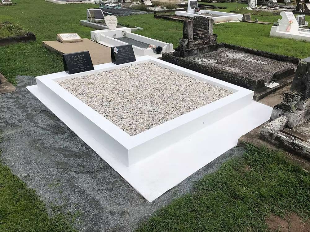 White Rectangular Tomb in a Cemetery, Filled With Small White Pebbles — Mackay Monumental Masons In Glenella, QLD