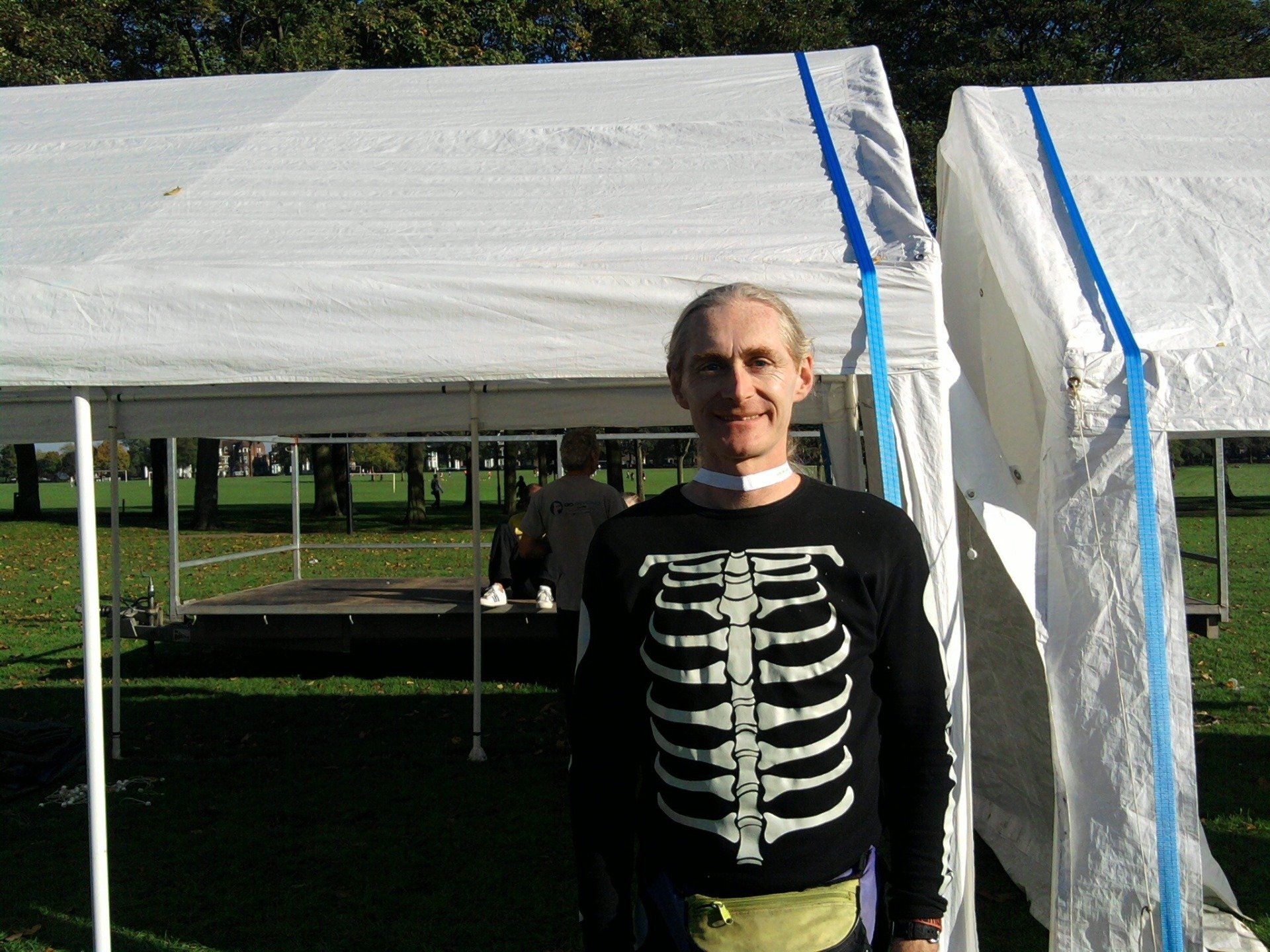 A man standing in a field with a Halloween costume on