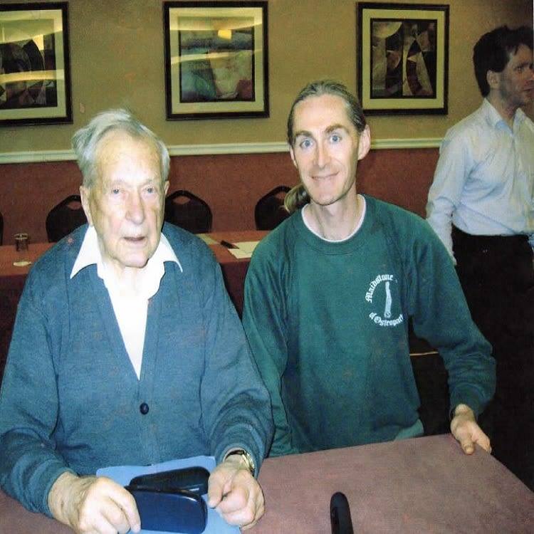 A picture of Neil Fraser and a friend at a restaurant.