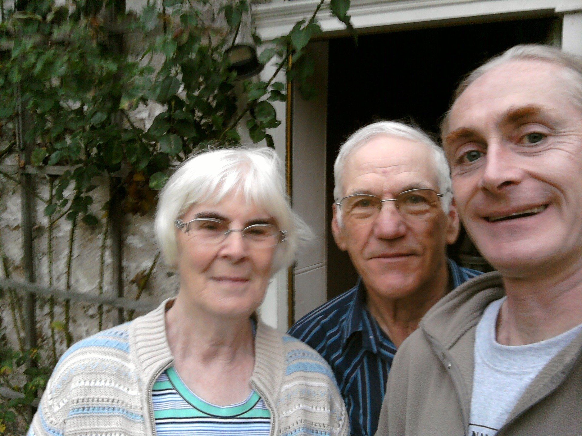 Neil Fraser and two of his friends smiling at the camera