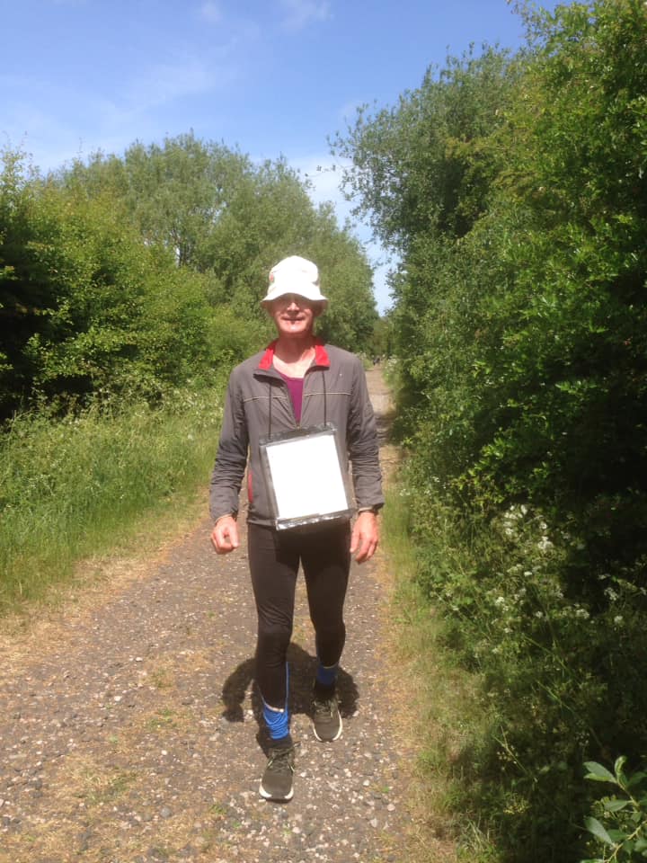 A man walking in an area of field