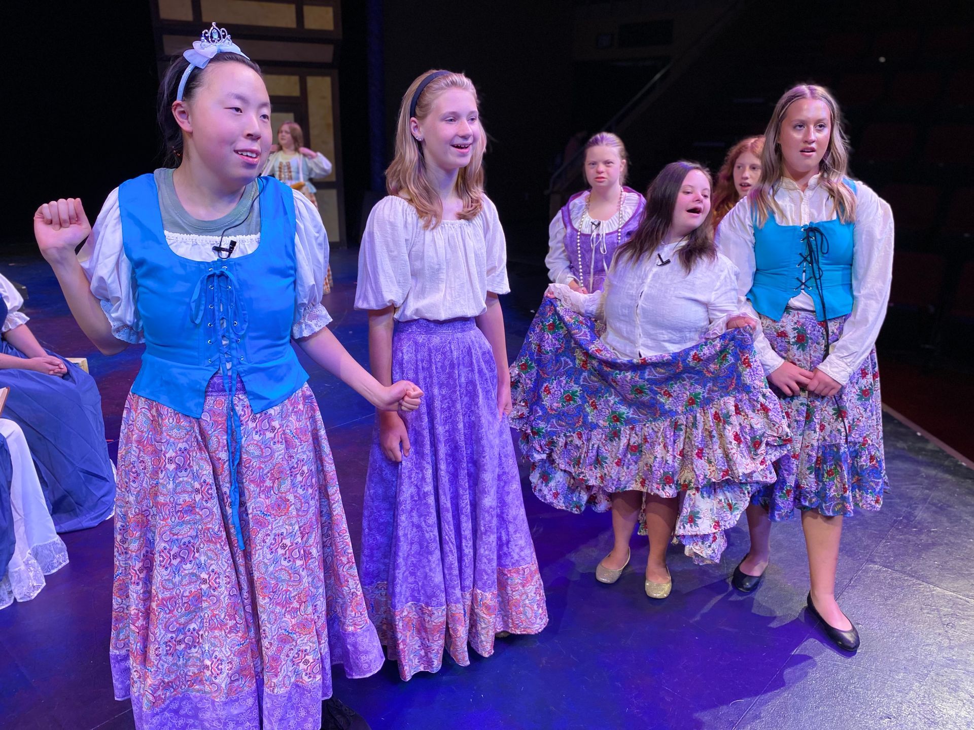 A group of young girls are standing on a stage.