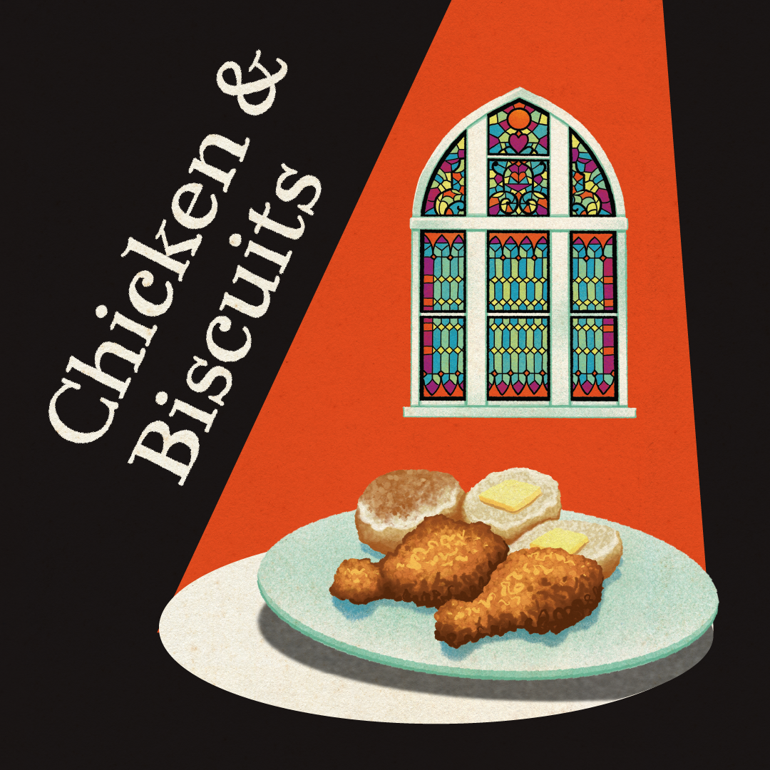 A plate of chicken and biscuits with a stained glass window in the background