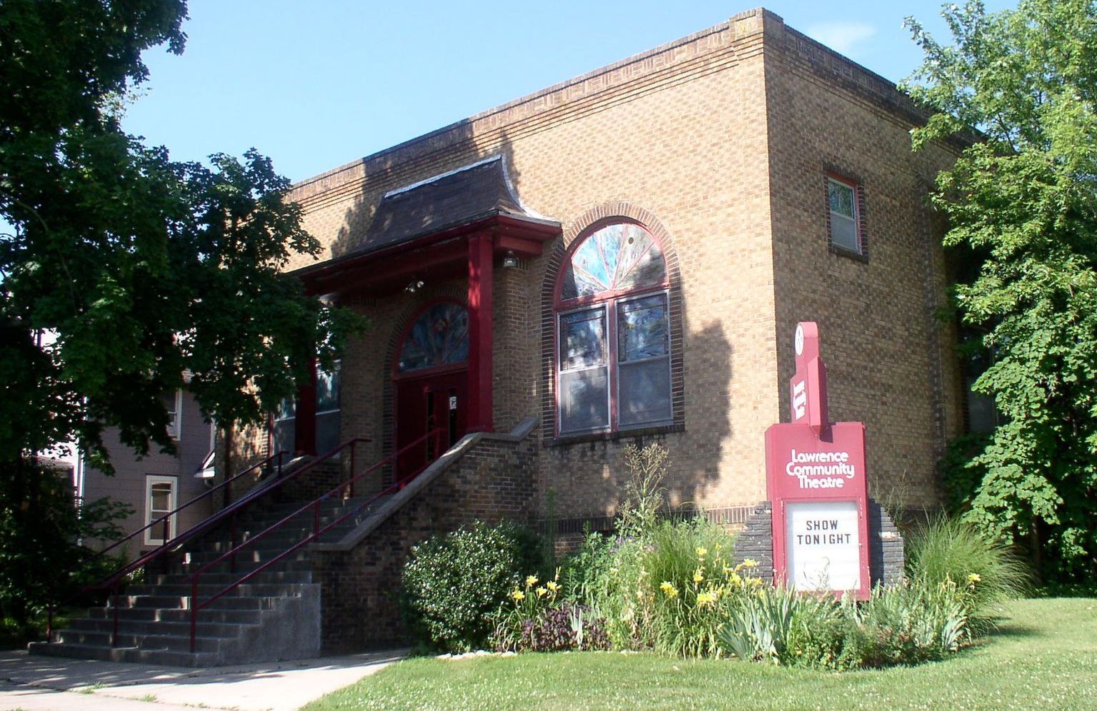 A brick building with a red sign that says let 's learn