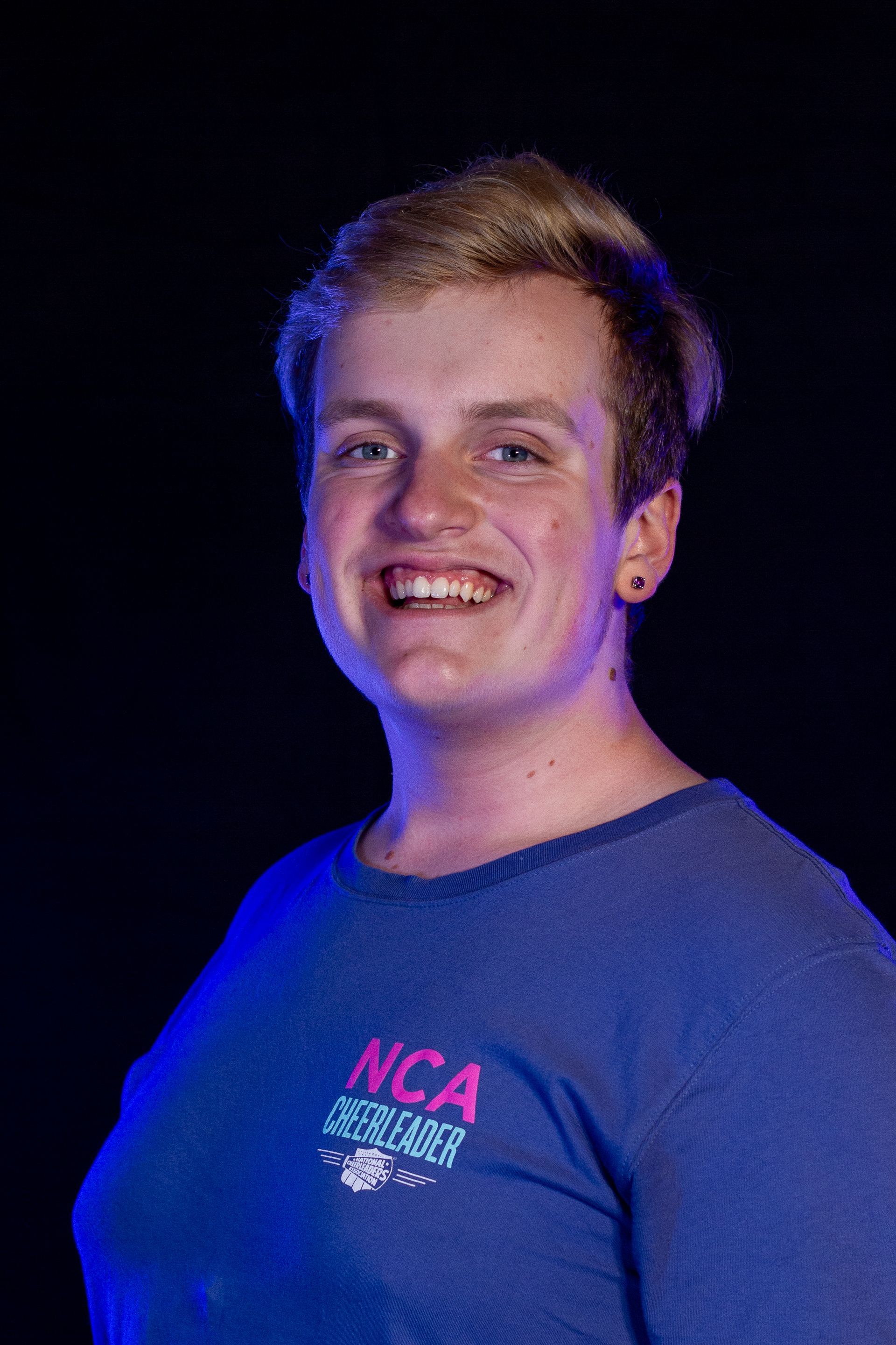 Smiling person in blue shirt,