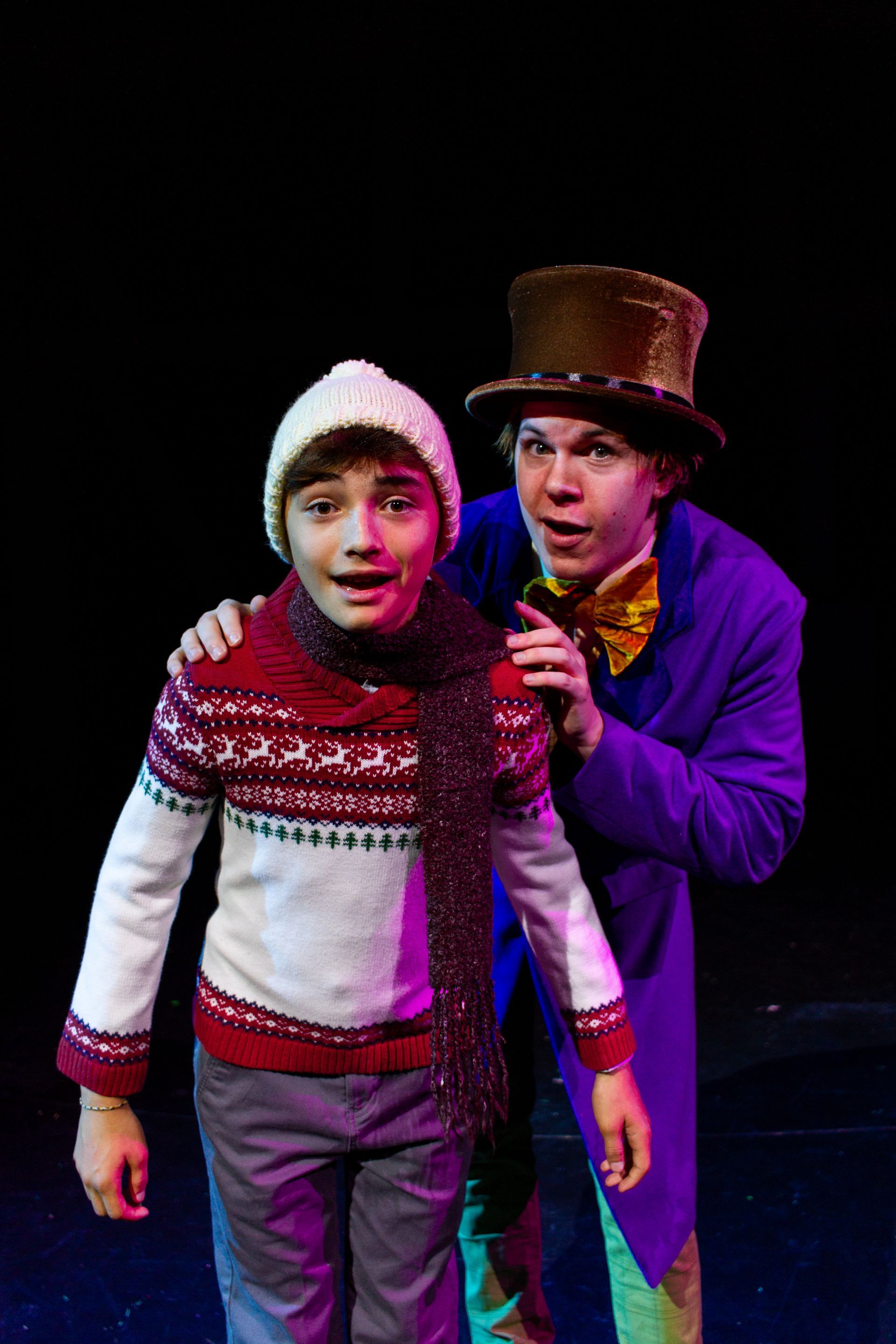 Charlie Bucket and Willy Wonka, stage, Charlie in sweater, Wonka in purple coat and hat.