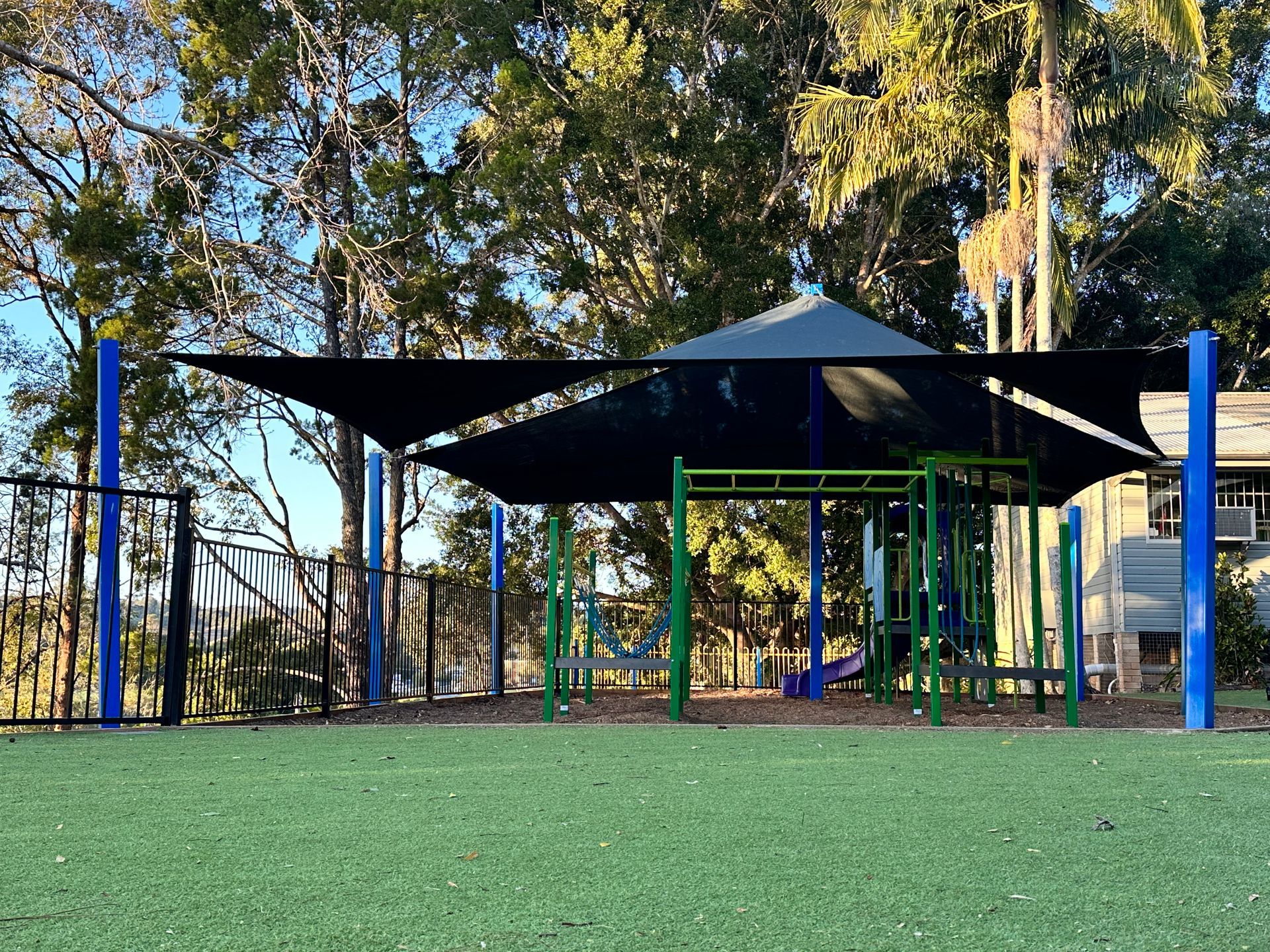 A playground with a canopy over it and trees in the background — SPF Shades and Sails in Tweed Heads West, NSW