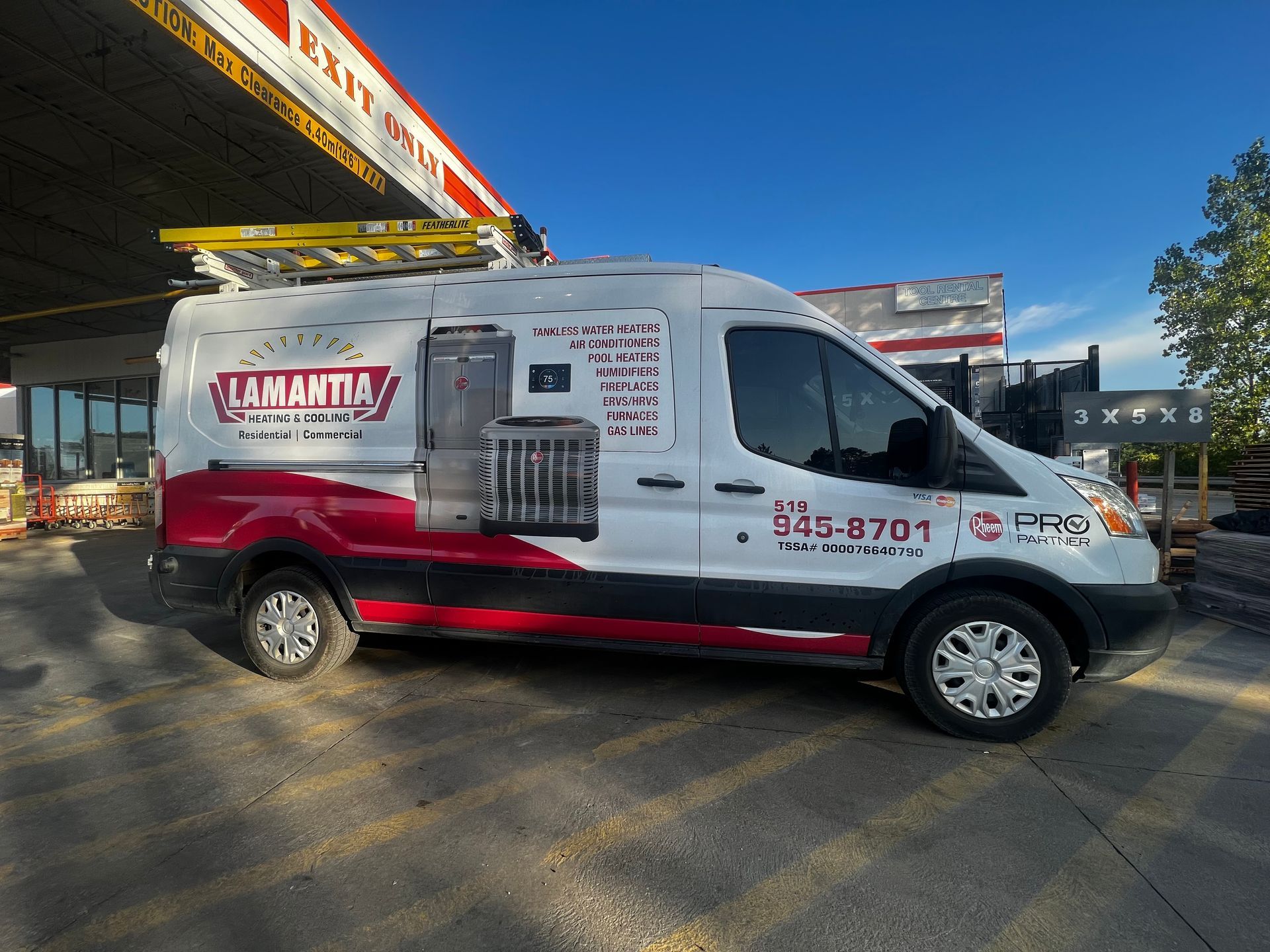 A red and white van is parked in front of a building.