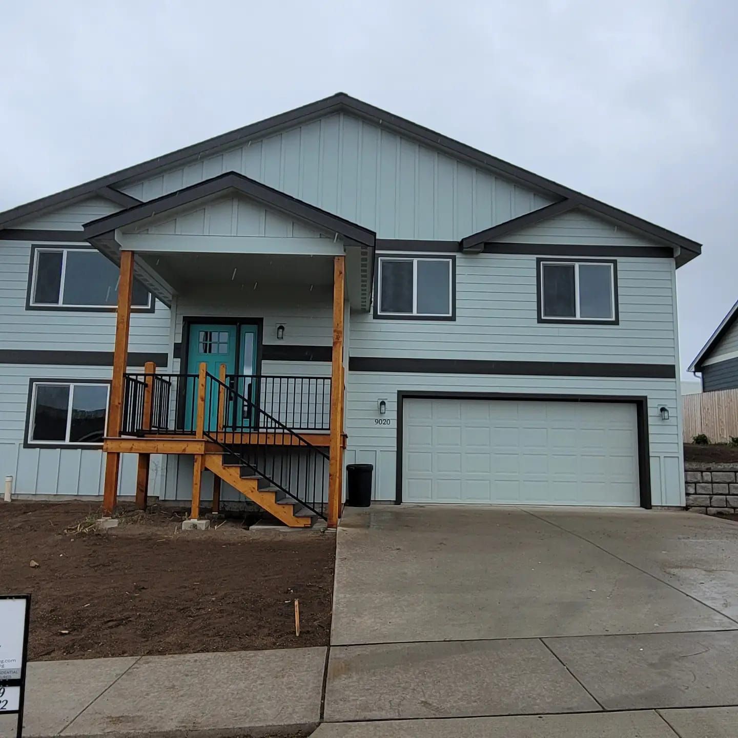 A large house with a for sale sign in front of it