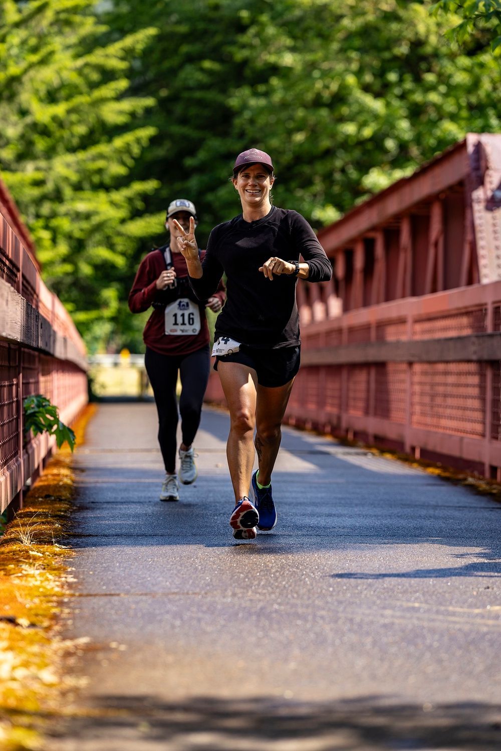 A man is running on a dirt road in the mountains.