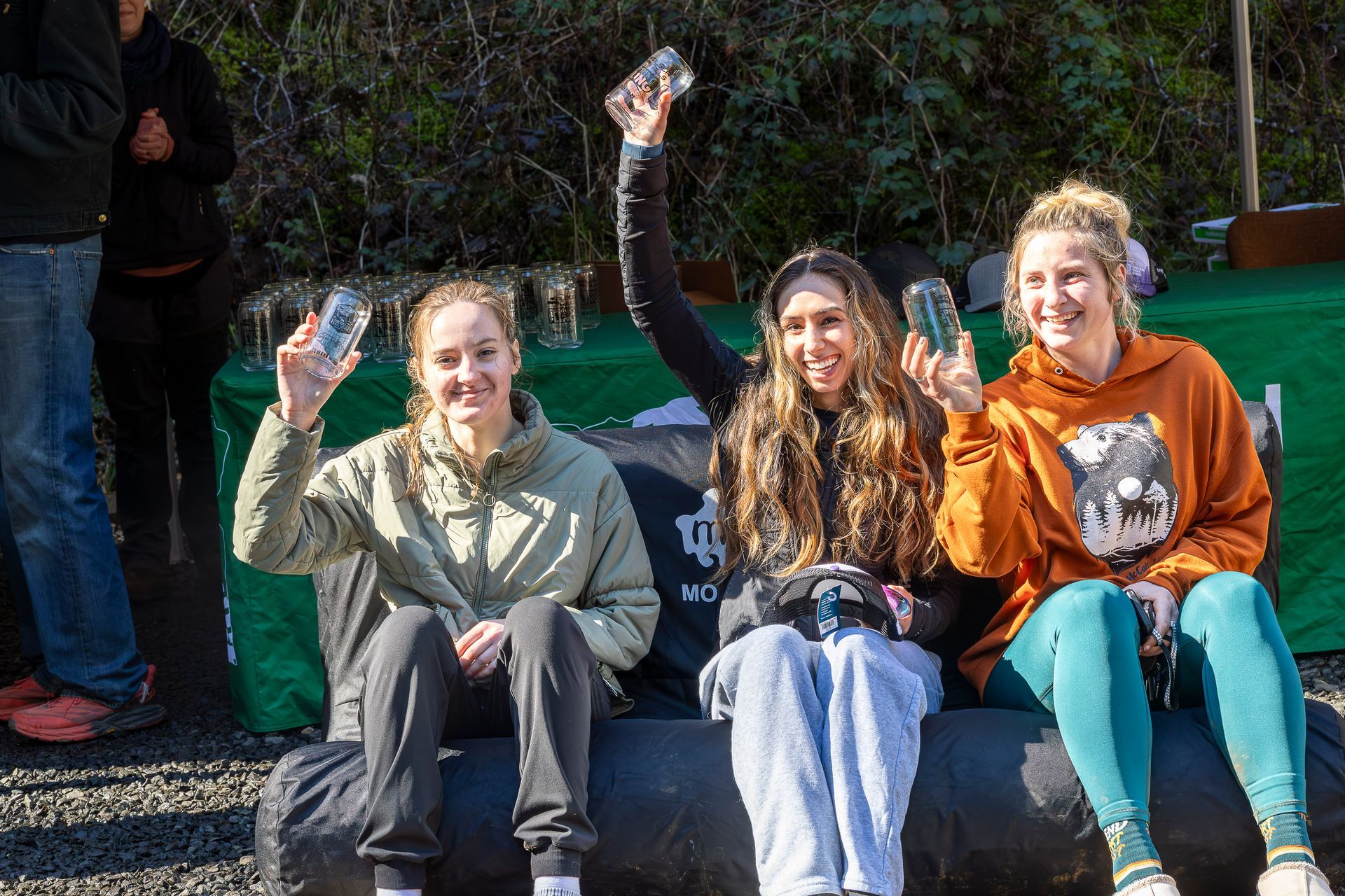 A group of people are running through a forest.