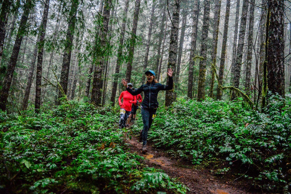 A man and a child are walking through a forest.