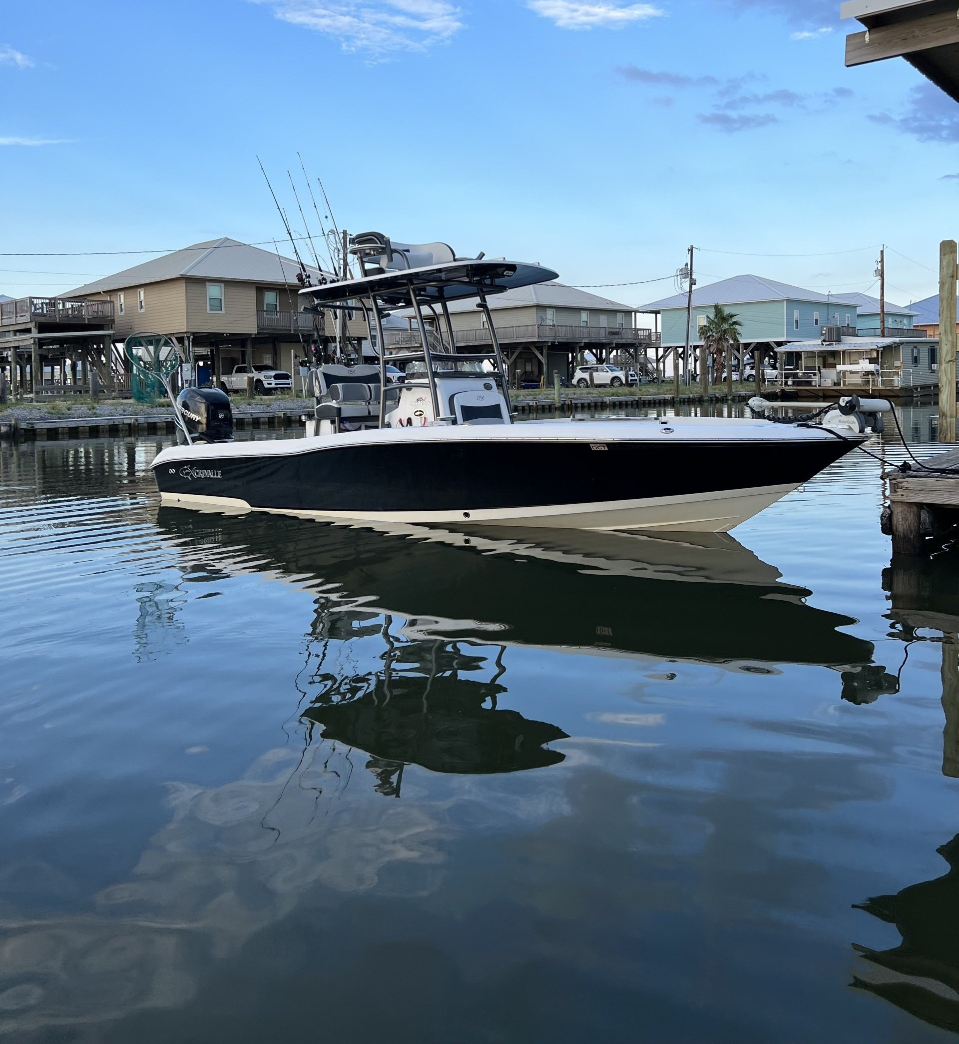 A boat is floating on a body of water near a dock