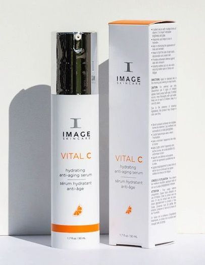 A bottle of image vital c next to its box