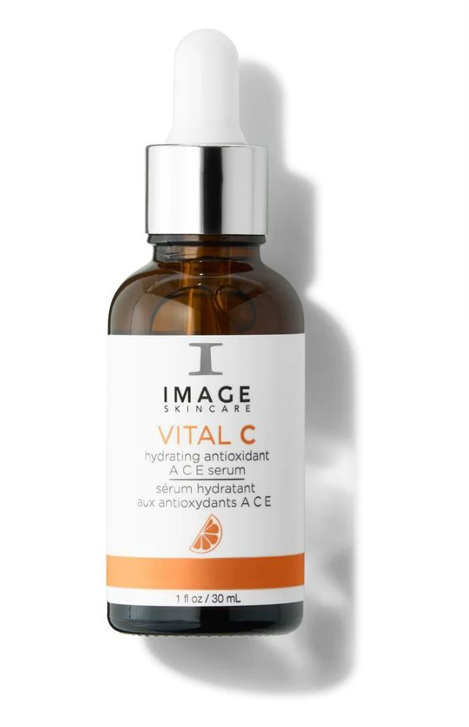 A bottle of image vital c serum with a dropper