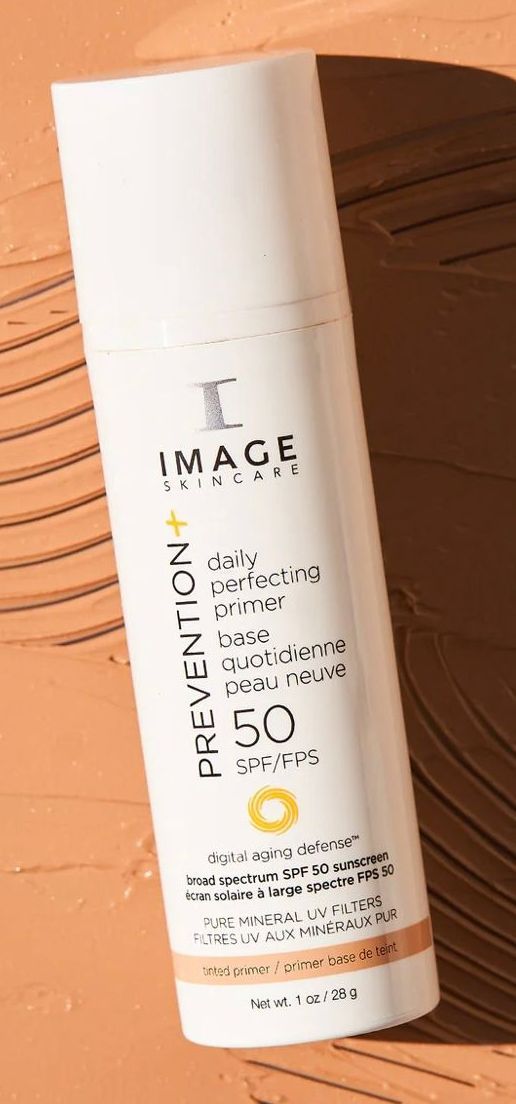 A bottle of image prevention sunscreen is sitting on a table.