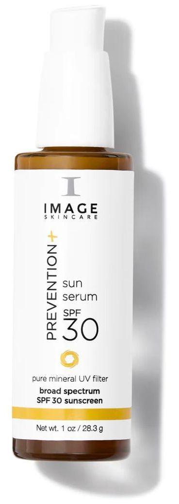 A bottle of image prevention sunscreen is sitting on a white surface.