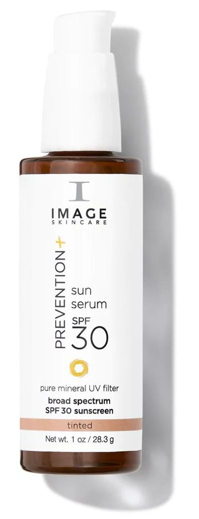 A bottle of image skincare sunscreen is sitting on a white surface.