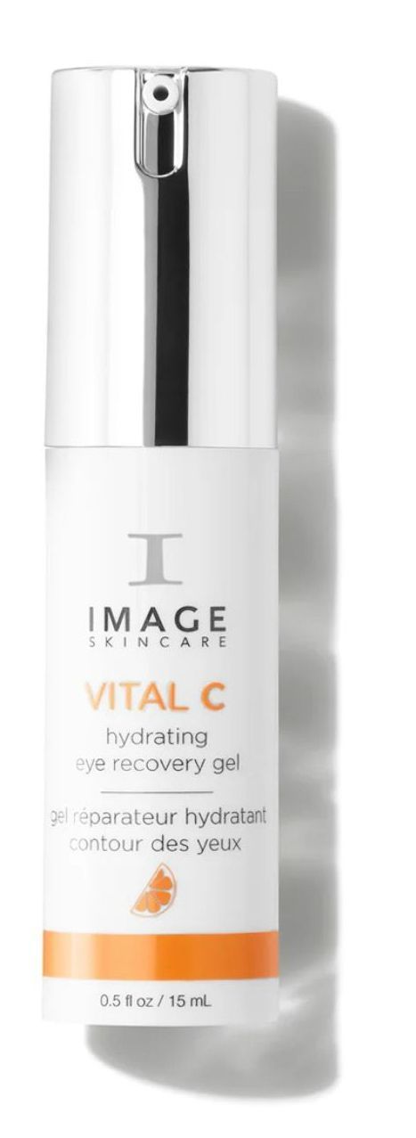 A bottle of image vital c eye cream is sitting on a white surface.