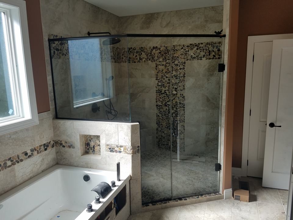 A bathroom with a walk in shower and a bathtub