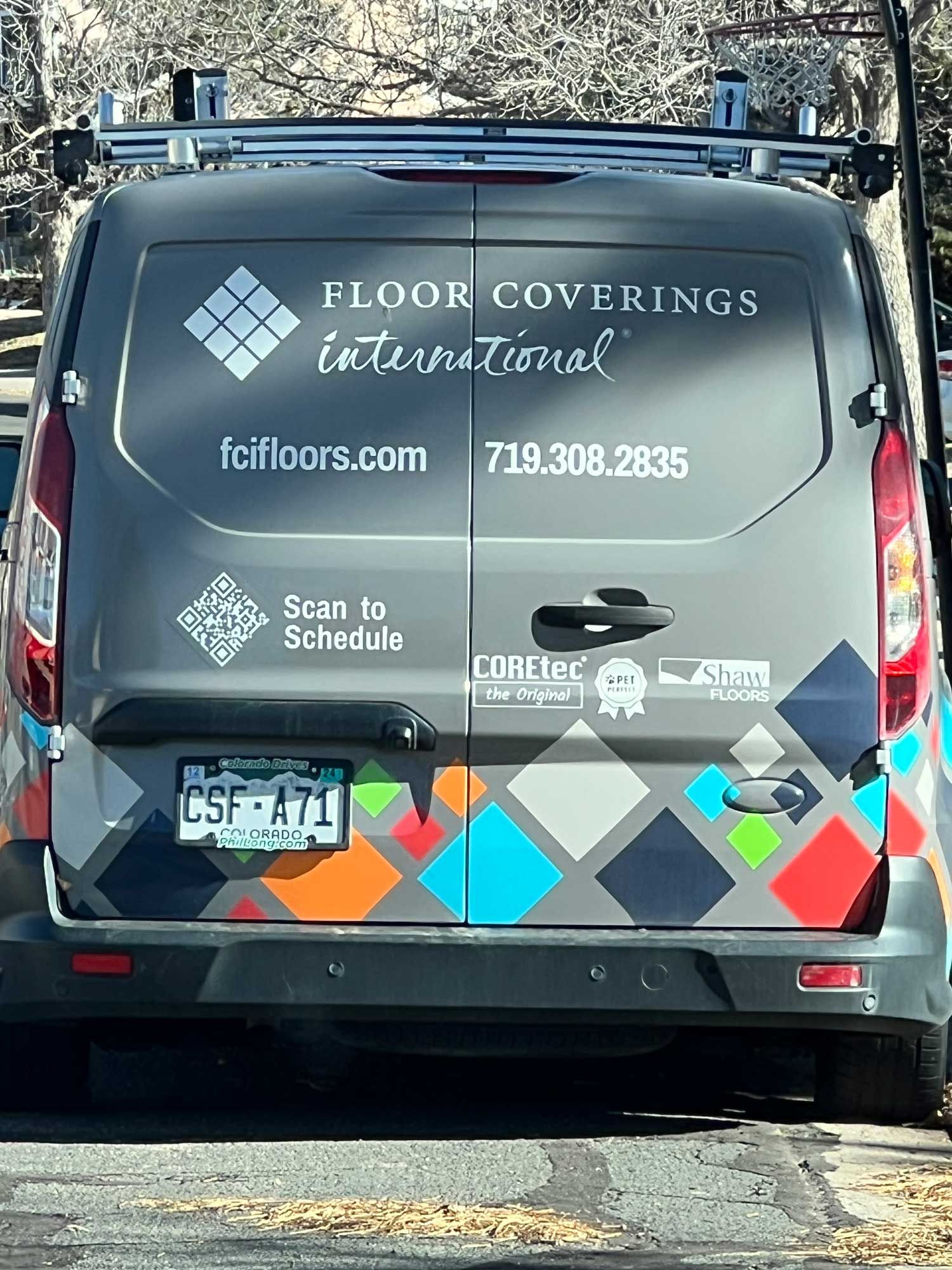 A floor coverings international van is parked on the side of the road