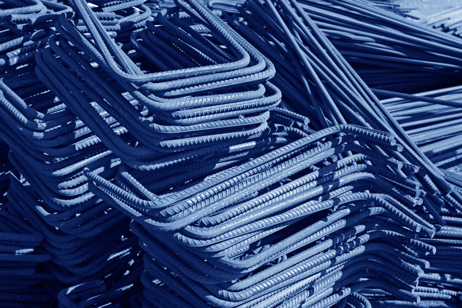 A pile of steel bars stacked on top of each other