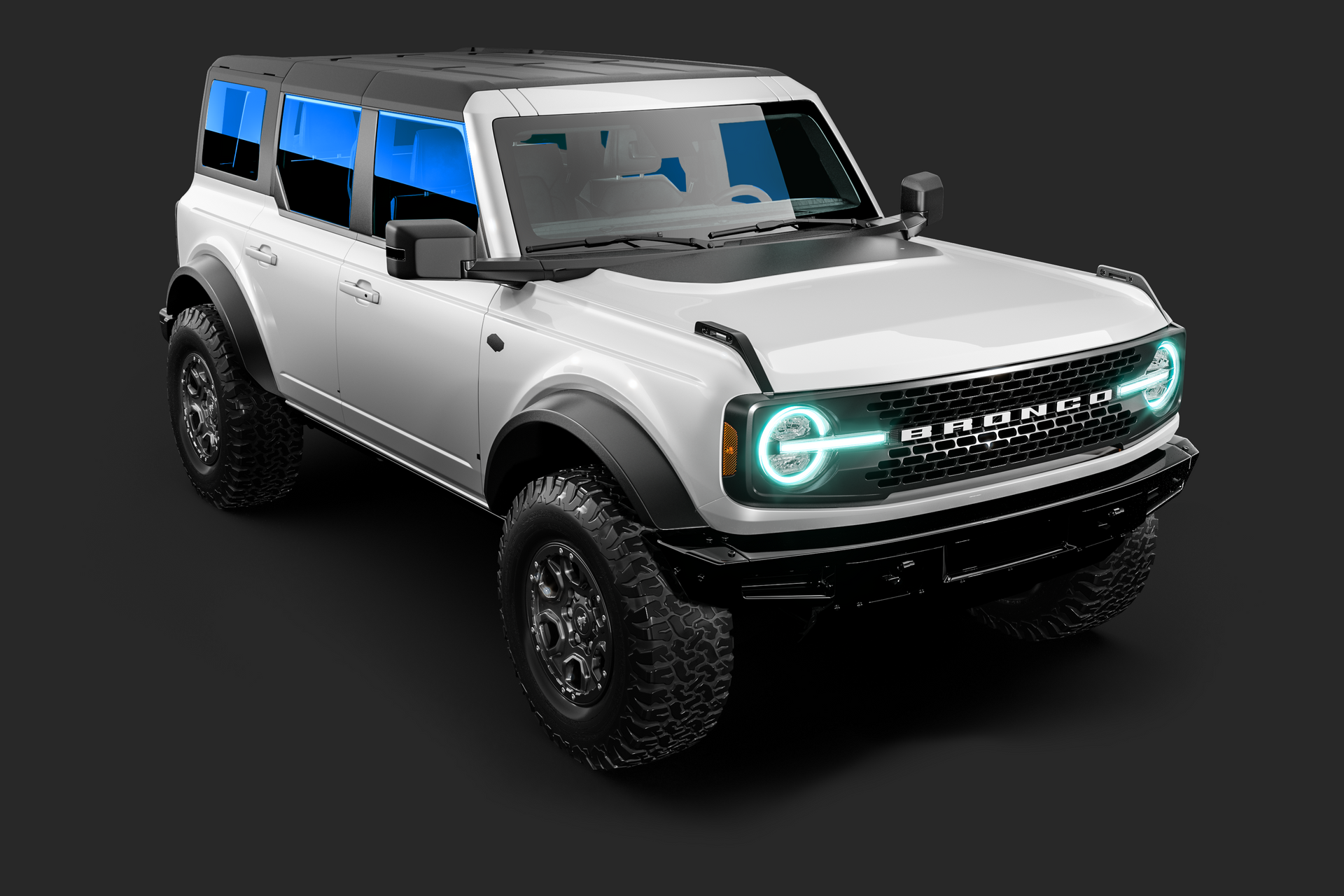 White Ford Bronco SUV, black accents, gray background, blue tinted windows.