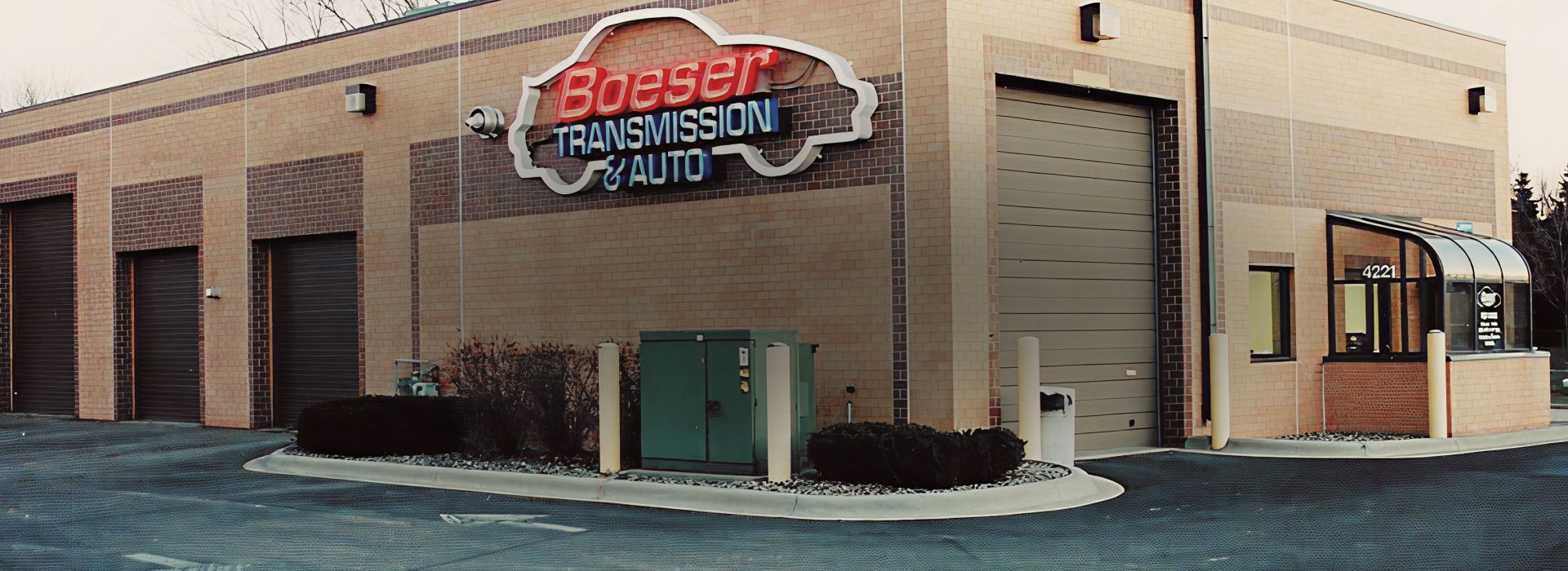 Grayscale exterior of a brick building with a sign reading “Jackson” above the entrance. | Boeser Automotive