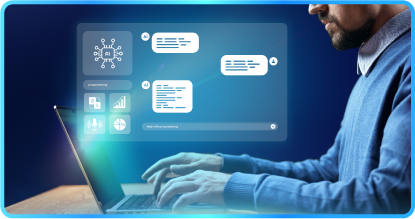 Man with glasses coding on a laptop, displaying a robot graphic, at a desk indoors.